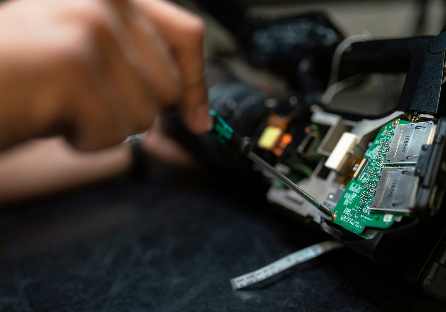 person holding green and black circuit board